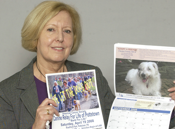 Lesley Duall holds up a picture of her dog and last year's Canine Relay