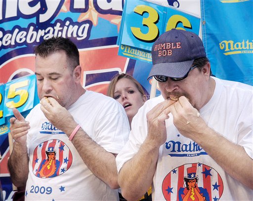 Bob Shoudt, right, of Royersford, stuff down hot dogs as Anastasia Clare